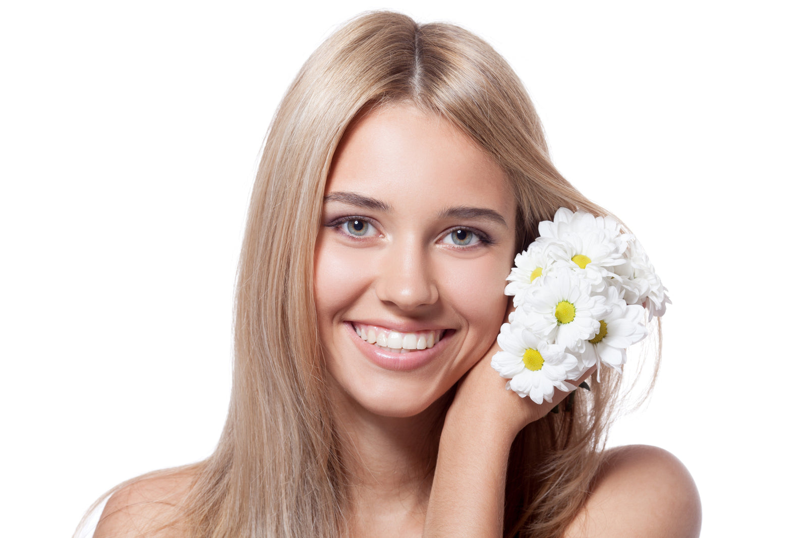 Woman with Shiny healthy hair holding chamomile flowers