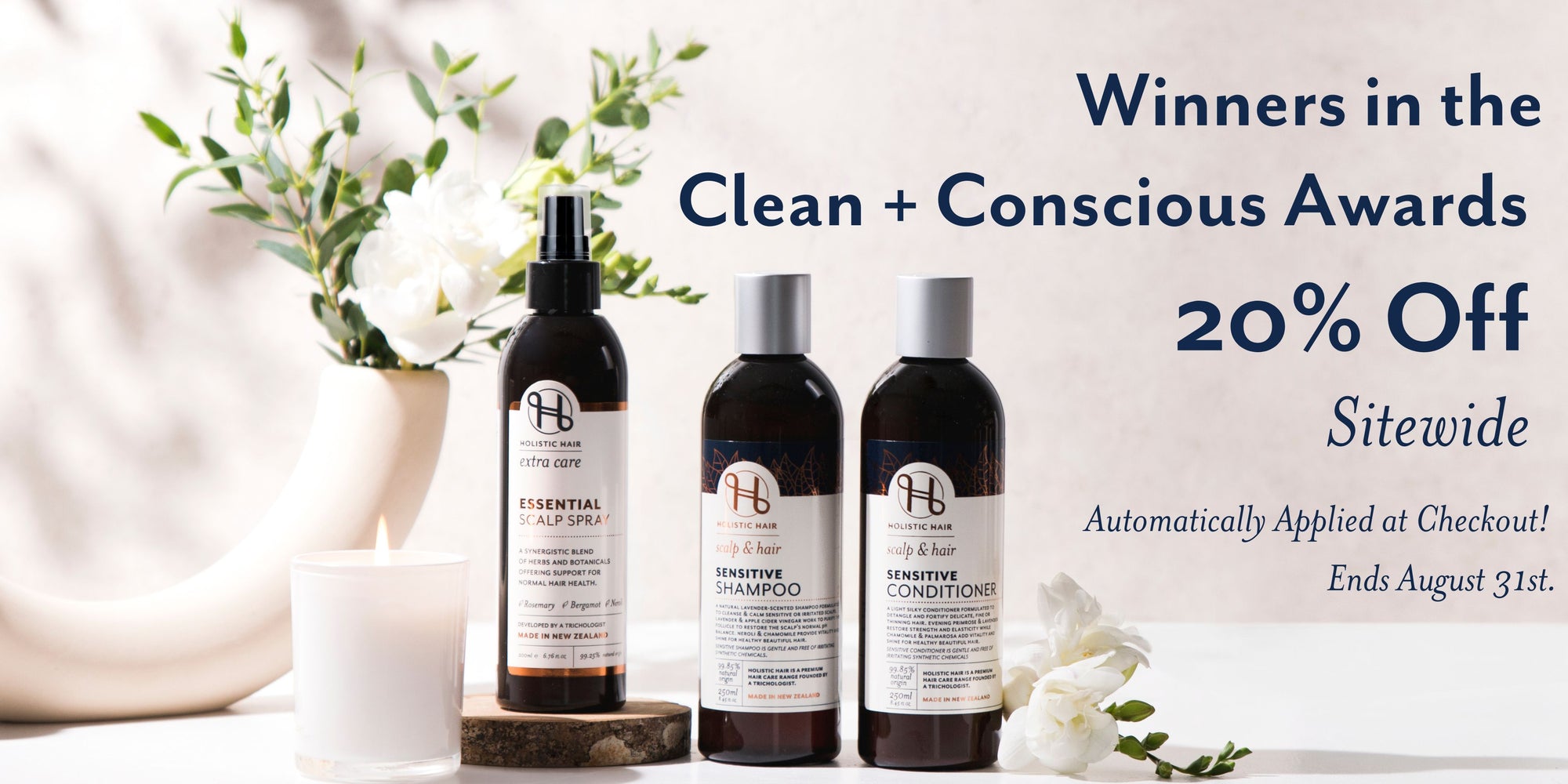 Three bottles of hair care products with a promotional banner for 'Winners in the Clean + Conscious Awards' and a discount offer.