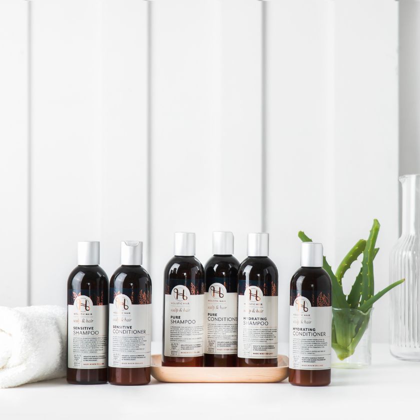 Image of Holistic Hair Shampoo & Conditioner range on a bathroom background.